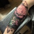 Typical combined and colored forearm tattoo of rose with diamond and ornaments