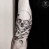 Typical engraving style black ink human skull with leaves