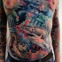 Typical multicolored underwater life with sharks and turtle tattoo on chest and belly