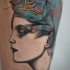Unfinished and colored tattoo of woman head with big lizard