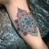 New school style colored arm tattoo of big ornamental flower