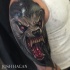 New school style colored shoulder tattoo of evil looking wolverine