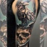 New school style colored shoulder tattoo of crow with human skull