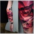 New school style colored arm tattoo of big red rose with ornaments