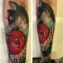 New school style colored forearm tattoo of impressive cat with rose and lettering
