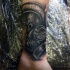 Unusual black ink ankle tattoo of broken gas mask