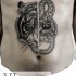 Unusual combined black and white tiger with snake tattoo on belly
