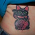 Unusual looking colored belly tattoo of maneki neko japanese lucky cat with needles