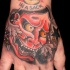 UOld school Asian traditional homemade painted colored arm tattoo of demonic face and stars