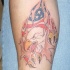Usa flag and eagle under skin rip tattoo on forearm