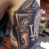 Usual colored and detailed dollar money bills tattoo on shoulder with old clock