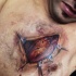 Very detailed natural looking colored ripped skin tattoo on chest with human heart