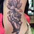 Vintage style black ink large hand with cross tattoo on side combined with beautiful flower