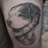 Vintage style black ink thigh tattoo of woman with dog mask