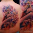 Watercolor style beautiful painted swan tattoo on back combined with flowers
