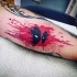 Watercolor style funny looking tattoo of Deadpool face