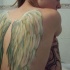 White wings tattoo on back for girls