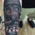 WW2 themed realism style very detailed soldier in gas mask tattoo on forearm combined with Tiger tank