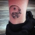 Yin Yang symbol dotted tattoo on ankle