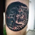 Yin Yang symbol shaped small old school style colored thigh tattoo of panther fighting tiger