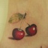 Tatuaje en el pie, dos cerezas apetitosas