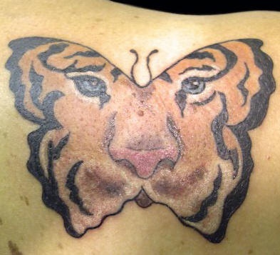Tiger eyes on butterfly tattoo