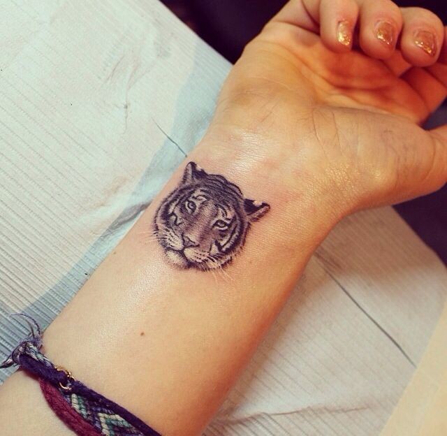 Tiger face tattoo on wrist