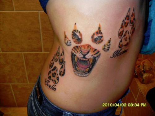 Tiger paws and head tattoo on side