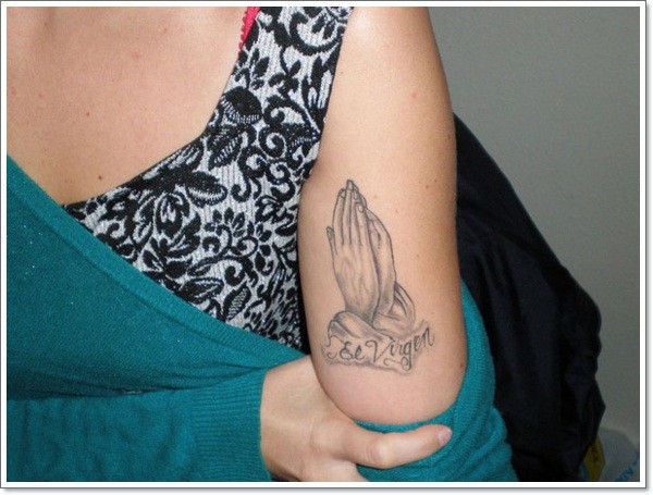 Tiny black ink usual praying hands tattoo on arm