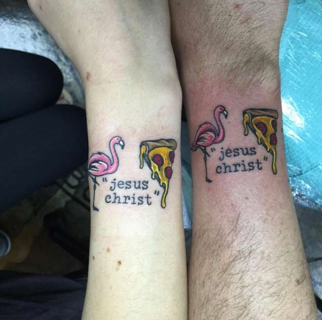 Tiny cartoon like unusual combined flamingo and pizza slice tattoo on wrist stylized with lettering