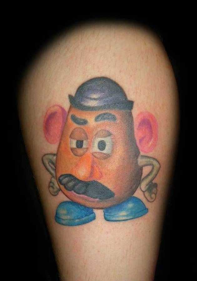 Tiny colored funny cartoon hero tattoo on leg
