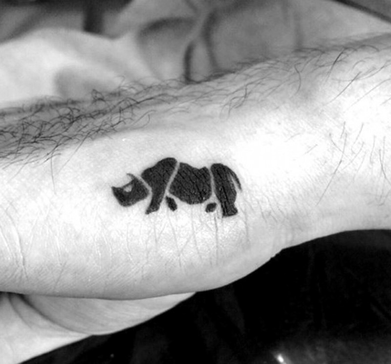 Tiny homemade black ink rhino tattoo on hand