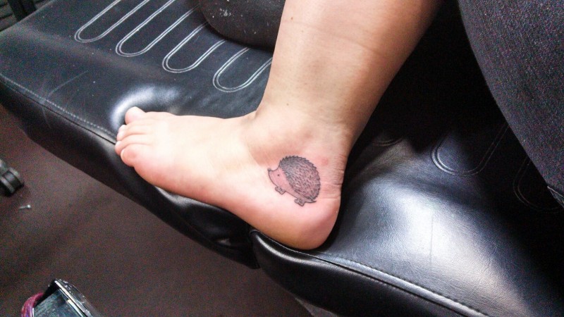 Tiny lovely gray-ink hedgehog tattoo for girls on foot