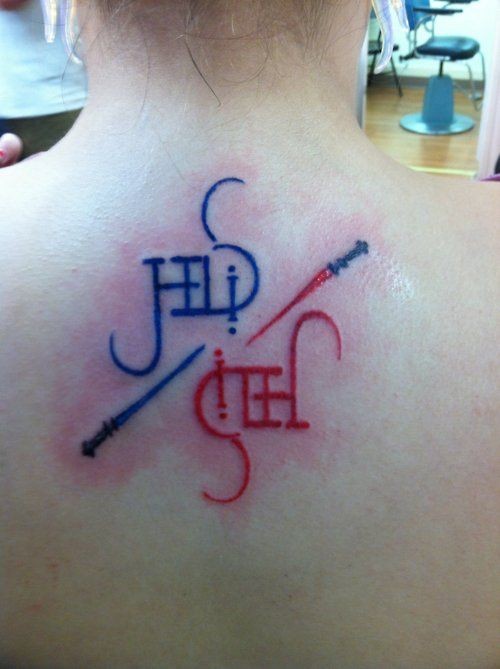 Tiny multicolored fantasy swords tattoo on upper back with lettering