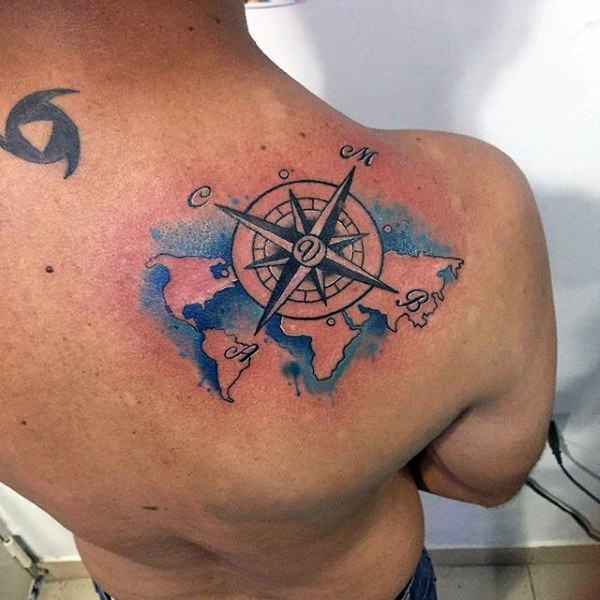 Tiny nautical themed colored world map tattoo on shoulder