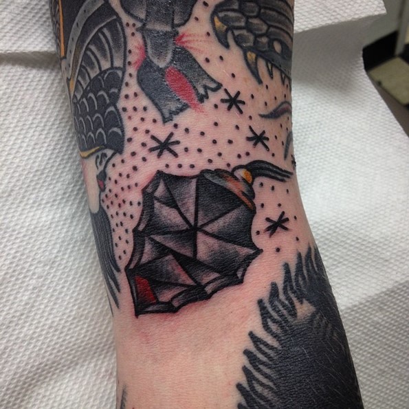 Tiny old school colored arrow head tattoo on arm with stars
