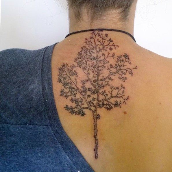 Tiny realistic looking black ink tree tattoo on neck