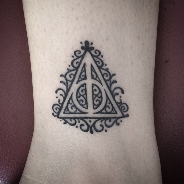 Tiny simple designed black ink triangle with circle tattoo