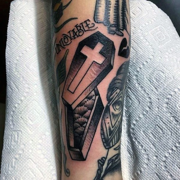 Tiny simple designed coffin tattoo on arm with lettering