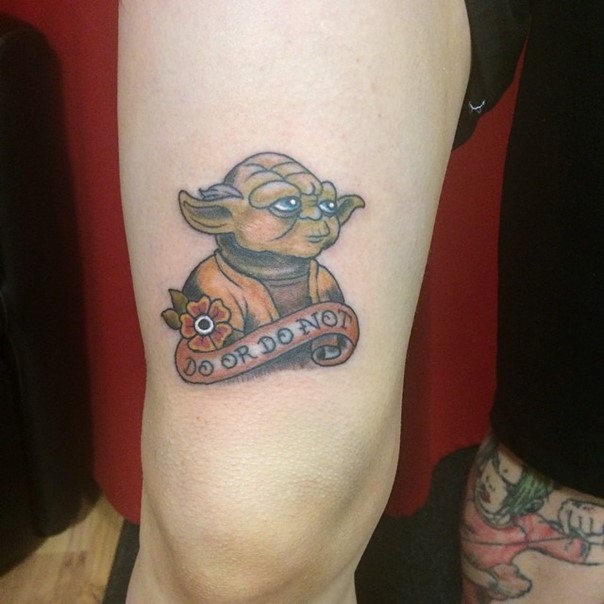 Tiny sweet colored thigh tattoo of Yoda with flower and lettering