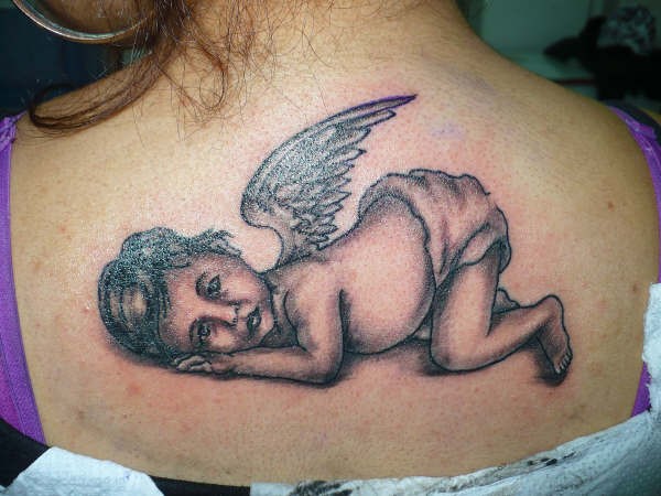 Tired little cherub tattoo on back
