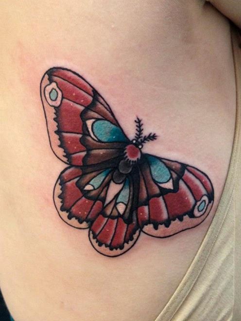 Traditional moth color ink tattoo on side rib