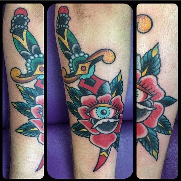 Traditional old school style sharp dagger with gems into rose flower colored tattoo with eye