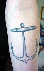 Traditional tattoo with small gray anchor