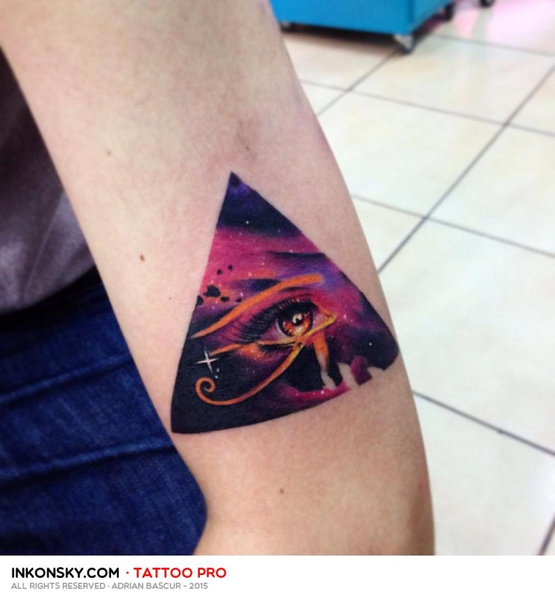 Triangle shaped colored arm tattoo stylized with Eye of Horus and space