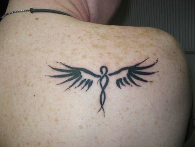 Tribal angel tattoo on the shoulder blade