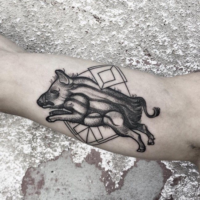 Tribal style black ink biceps tattoo with geometrical figures