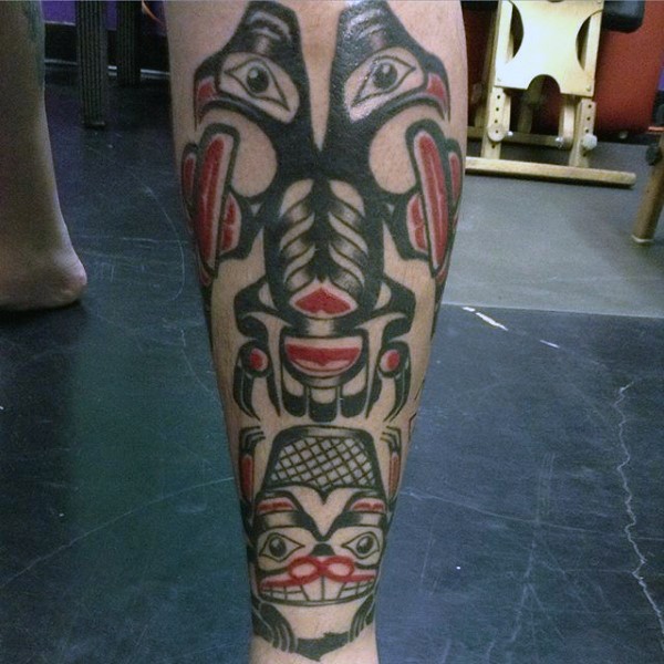Tribal style colored Alien like monsters tattoo on leg