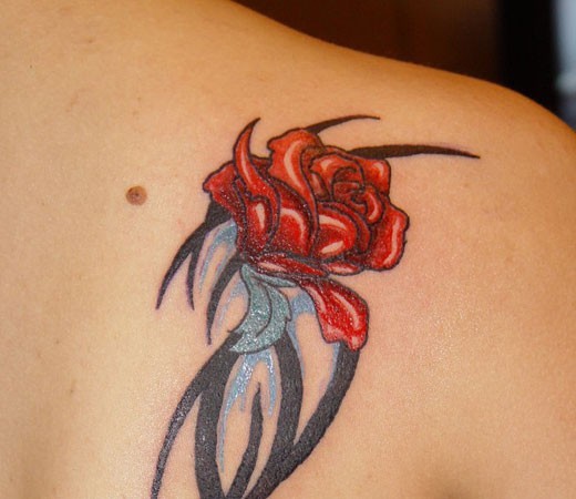 Tribal style little black ink symbol tattoo combined with red rose