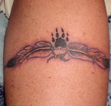 Two feathers with paw print tattoo